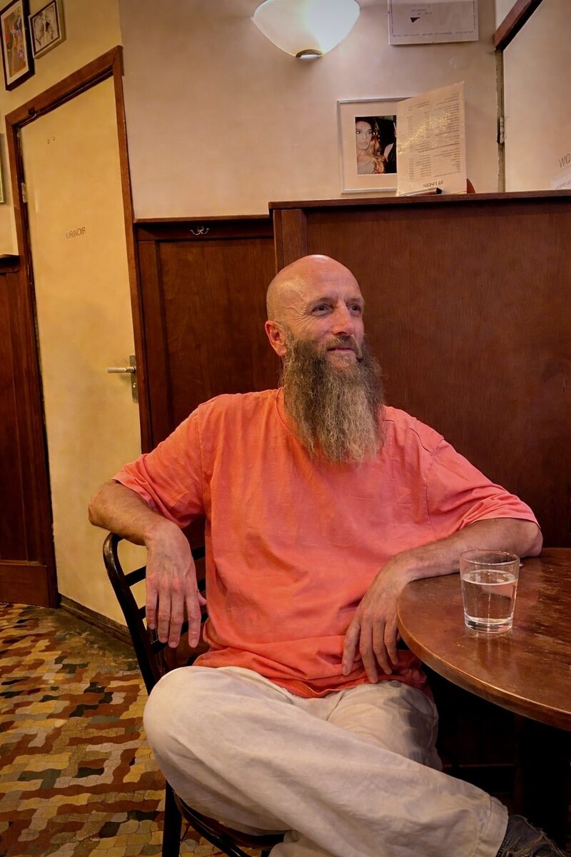 Peter Adams sitting at a cafe table